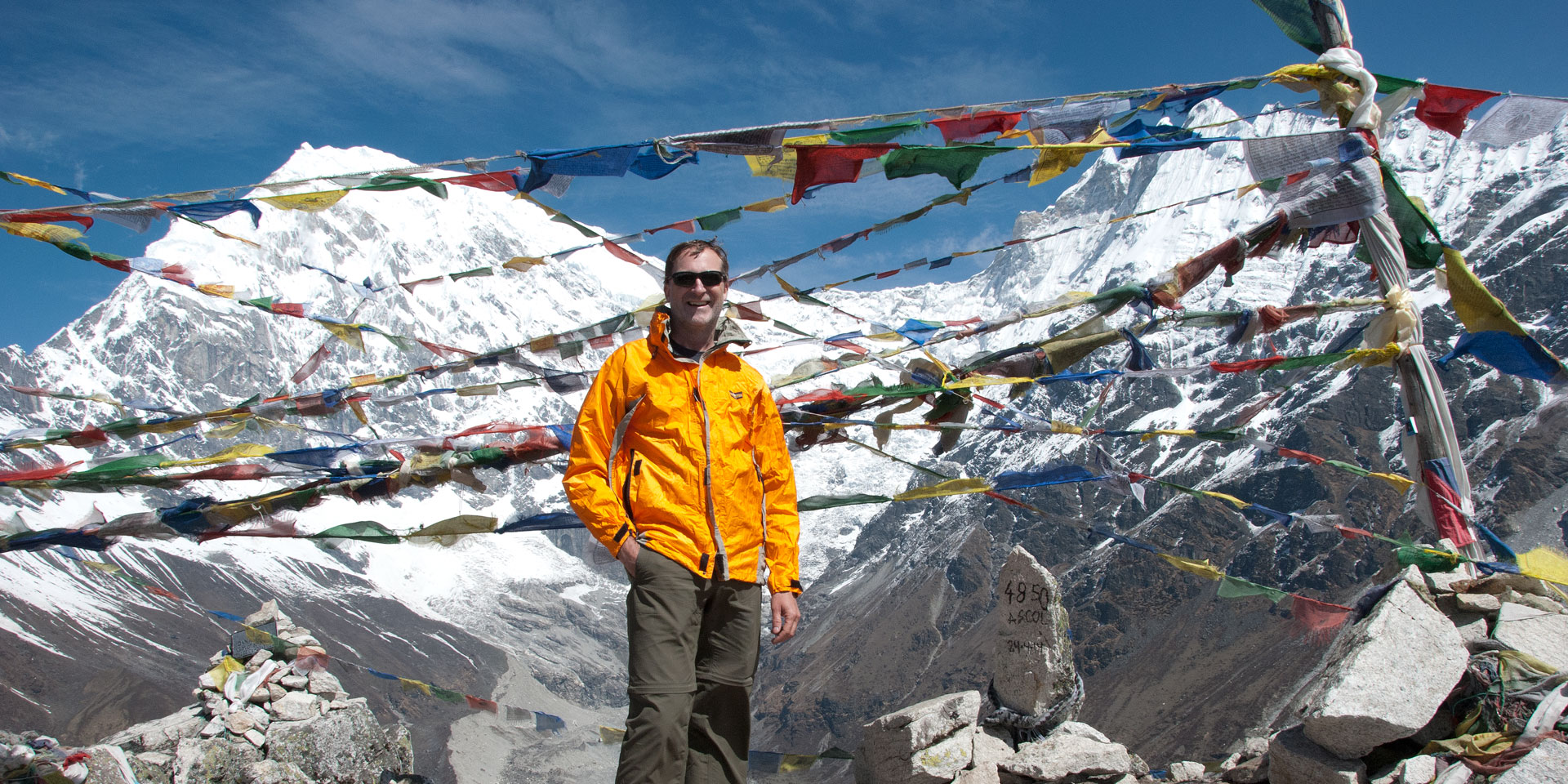 Trekker on top of Kyangjin Ri with Langtang Lirung mountain in the background
