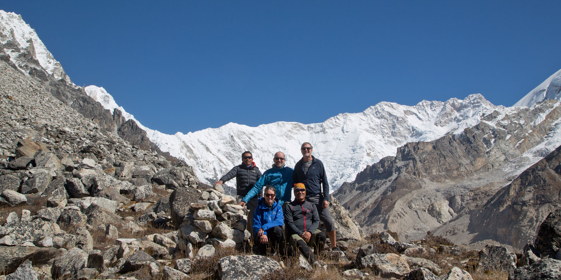Group posing in front of Kanchenjunga at Oktang near the south Base camp in eastern Nepal