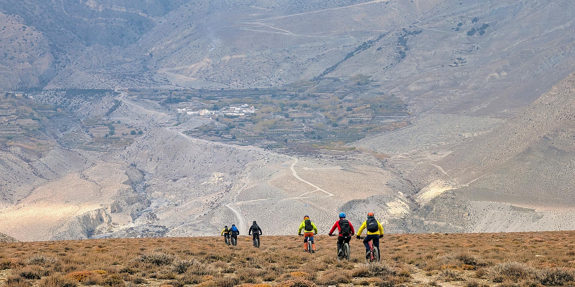 Riders descending from Lupra to Ekle Bhatti in the Kali Gandaki valley of Lower Mustang. Across the valley is hte village of Phallyak